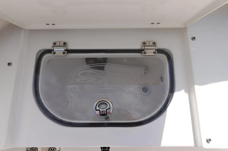Slide: The Image of 2023 Sea Hunt Escape 28 boat compartment with transparent lid and secure latch. - 9