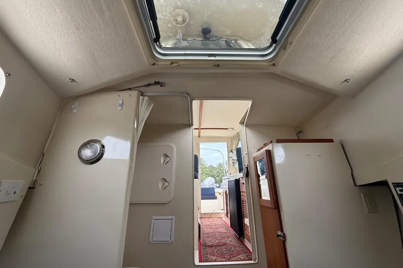 Slide: The Image of Interior view of 2008 Rosborough RF-246 Sedan Cruiser, featuring a skylight and compact cabin layout. - 13
