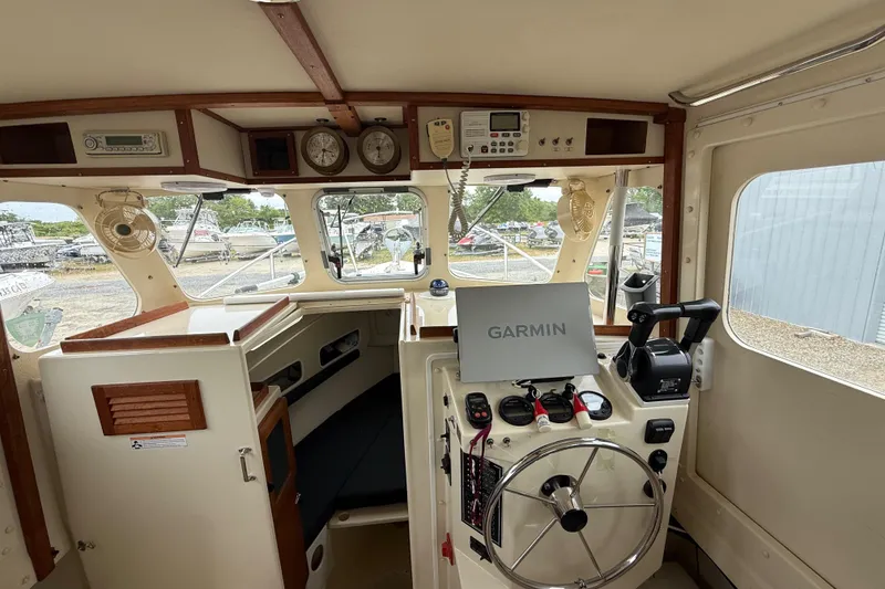 Slide: The Image of 2008 Rosborough RF-246 Sedan Cruiser interior with Garmin navigation system and classic wooden accents. - 18