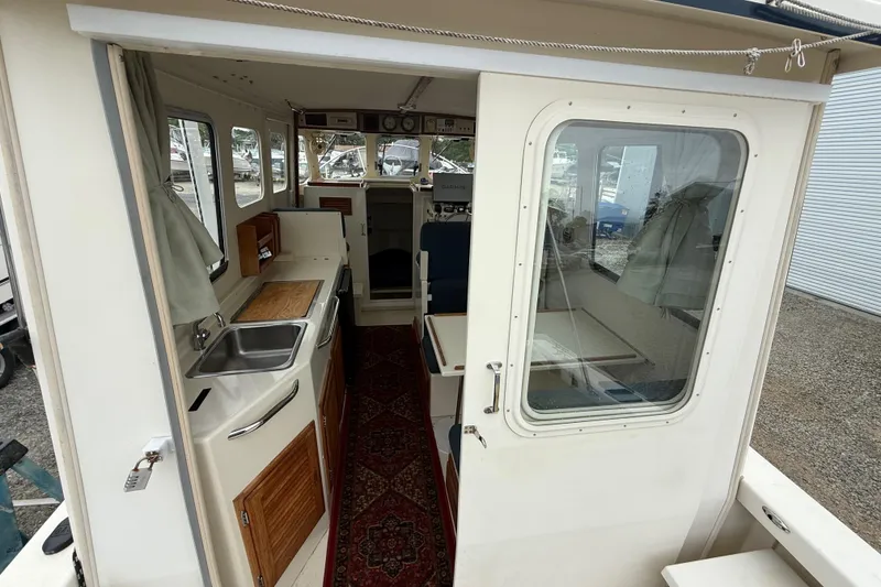 Slide: The Image of 2008 Rosborough RF-246 Sedan Cruiser interior with kitchenette and seating area. - 19