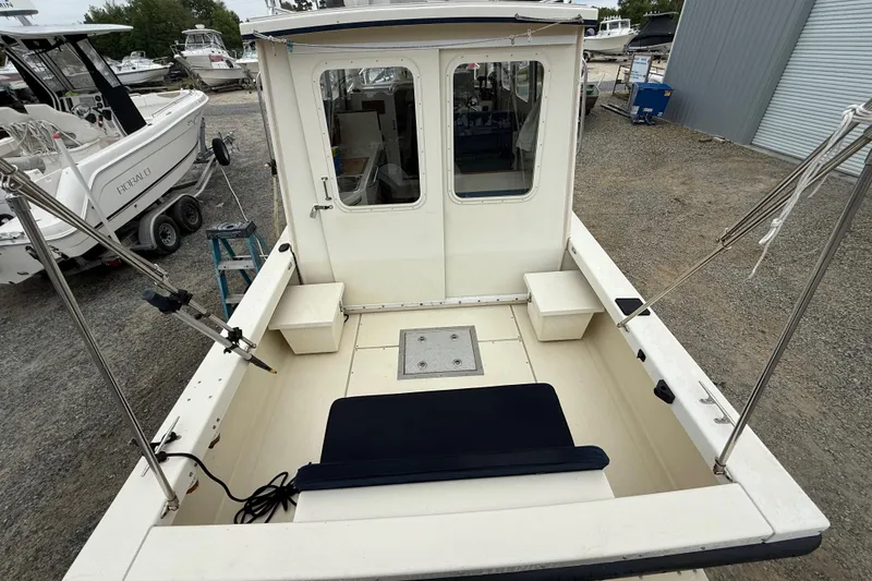Slide: The Image of 2008 Rosborough RF-246 Sedan Cruiser, rear deck view, parked in a boatyard. - 4