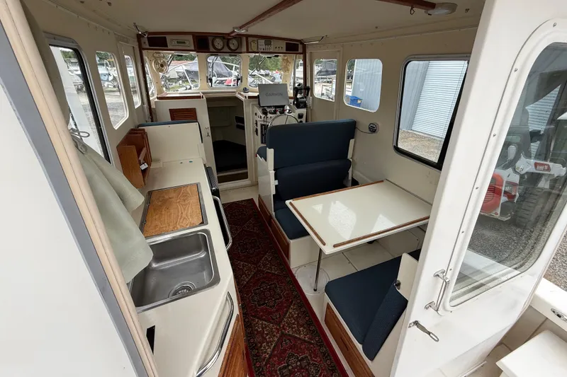 Slide: The Image of 2008 Rosborough RF-246 Sedan Cruiser interior with seating, table, and kitchenette. - 5
