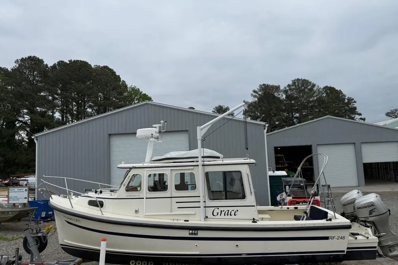 Slide: The Image of 2008 Rosborough RF-246 Sedan Cruiser docked near gray storage buildings. - 6