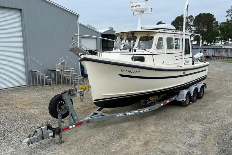 Slide: The Image of 2008 Rosborough RF-246 Sedan Cruiser on trailer, parked near industrial buildings. - 7