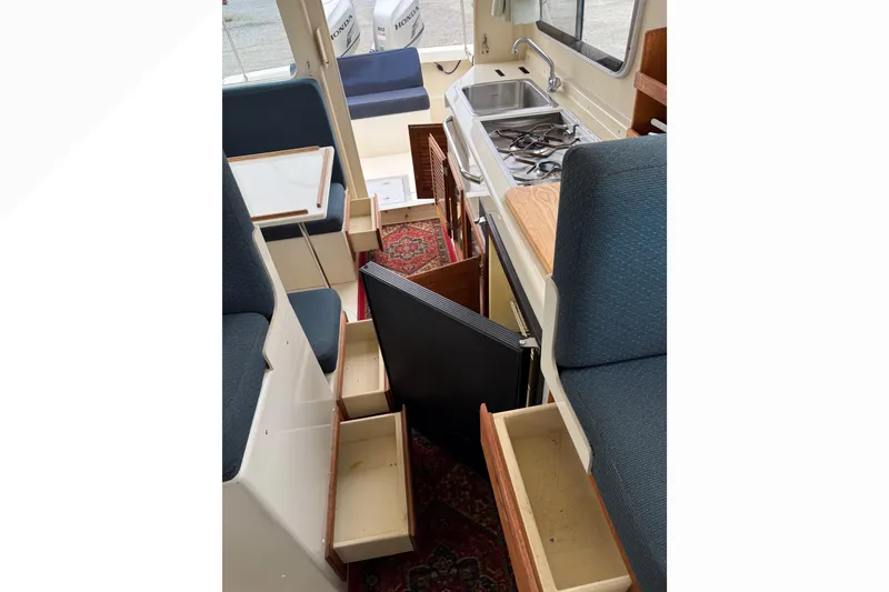 Slide: The Image of Interior of 2008 Rosborough RF-246 Sedan Cruiser with kitchen and seating area. - 9
