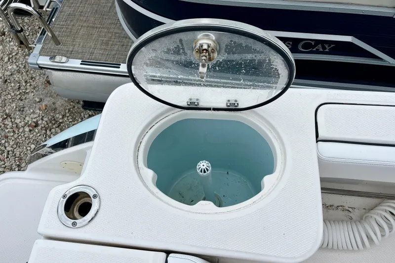 Slide: The Image of Livewell on 2024 Robalo R230 Center Console boat, open lid, white interior. - 11