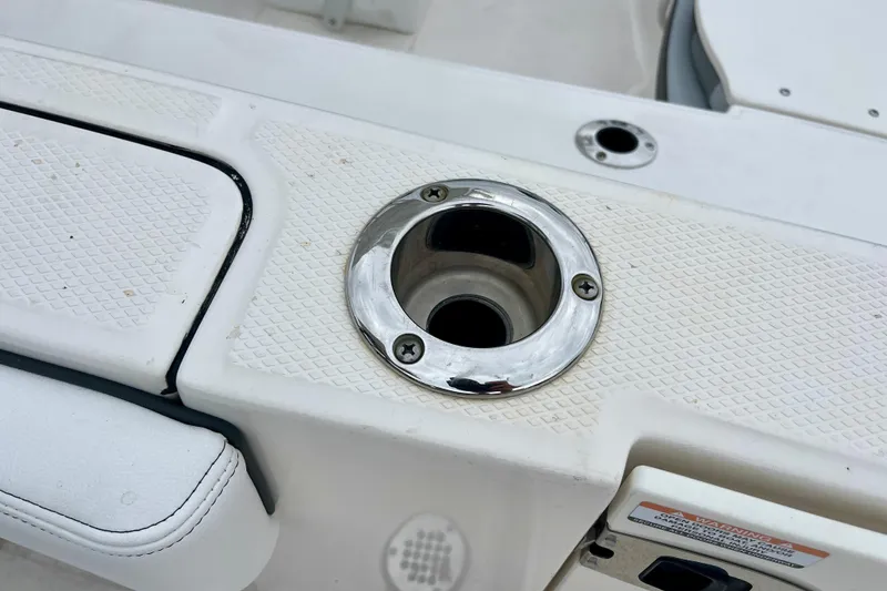 Slide: The Image of 2024 Robalo R230 Center Console boat with stainless steel cup holder detail. - 13
