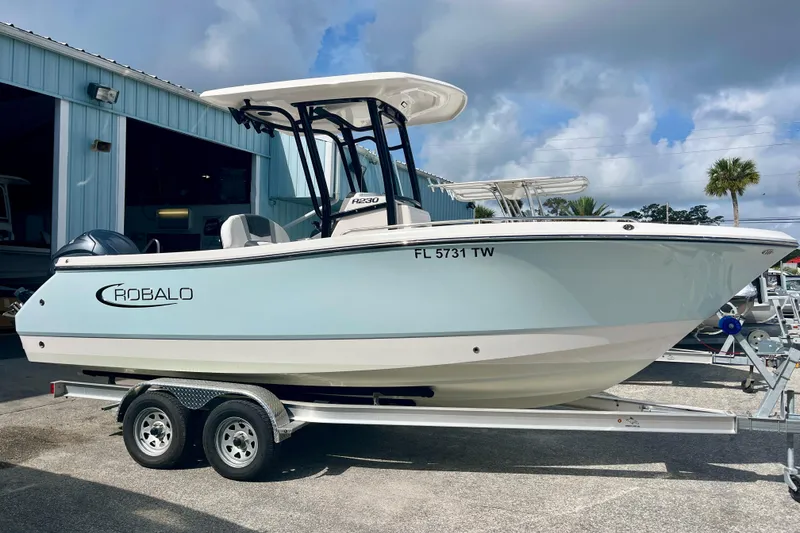 The Image of 2025 Robalo R230 Center Console on trailer outside warehouse. - 0