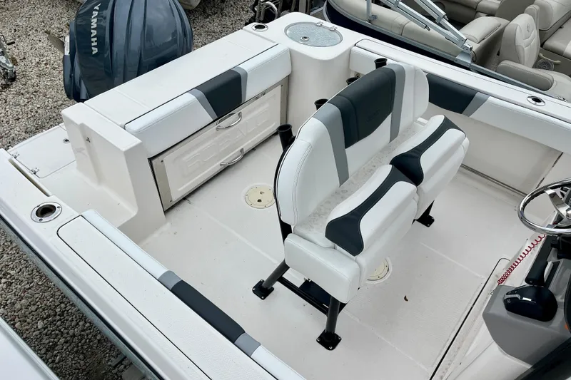 Slide: The Image of 2024 Robalo R230 Center Console boat interior with seating and Yamaha engine. - 11