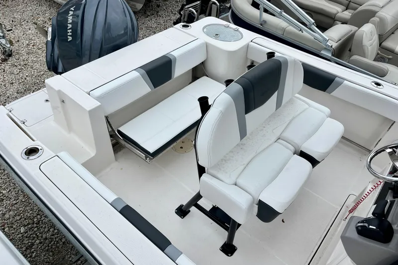 Slide: The Image of 2024 Robalo R230 Center Console boat interior with seating and Yamaha engine. - 12