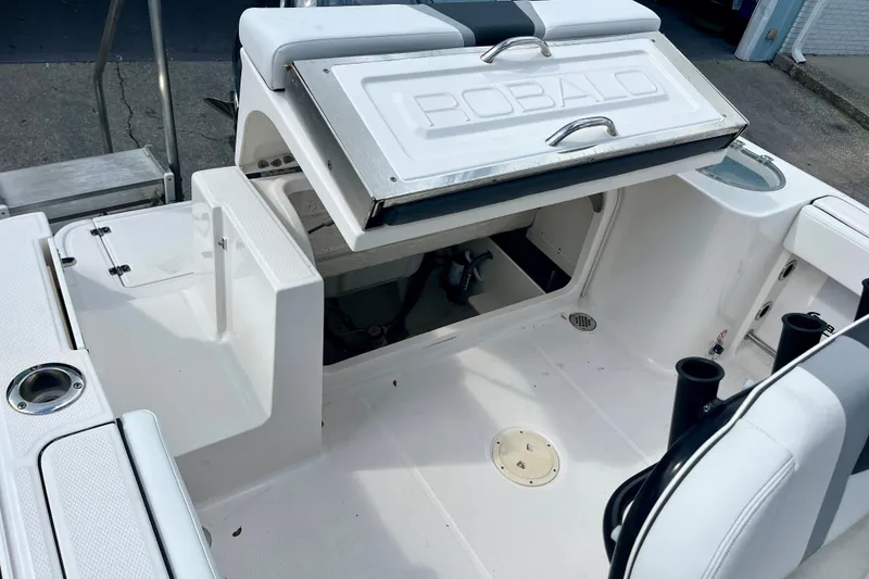 Slide: The Image of 2025 Robalo R230 Center Console boat interior with open storage compartment. - 15