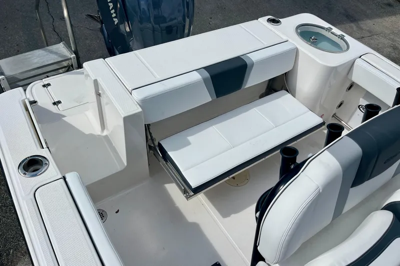 Slide: The Image of 2025 Robalo R230 Center Console boat interior with seating and Yamaha engine. - 16