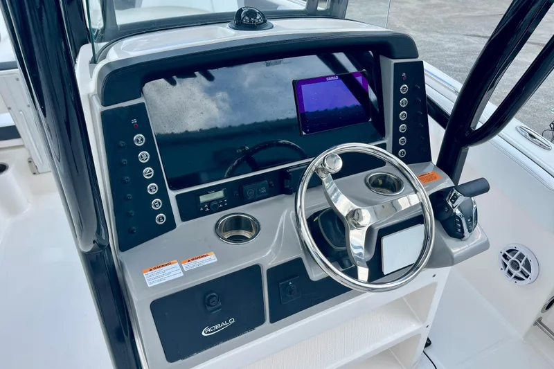 Slide: The Image of 2025 Robalo R230 Center Console helm with modern electronics. - 18