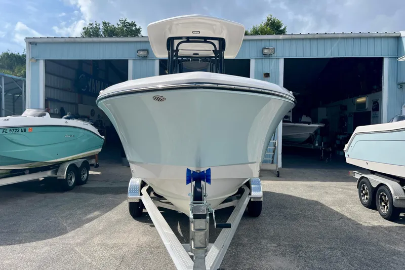 Slide: The Image of 2025 Robalo R230 Center Console on trailer outside storage. - 2