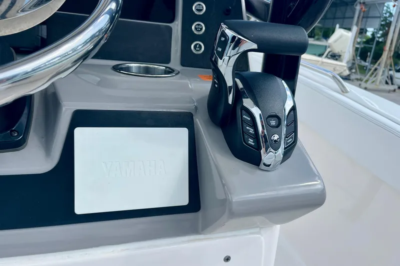 Slide: The Image of 2025 Robalo R230 Center Console helm with Yamaha controls and steering wheel. - 22