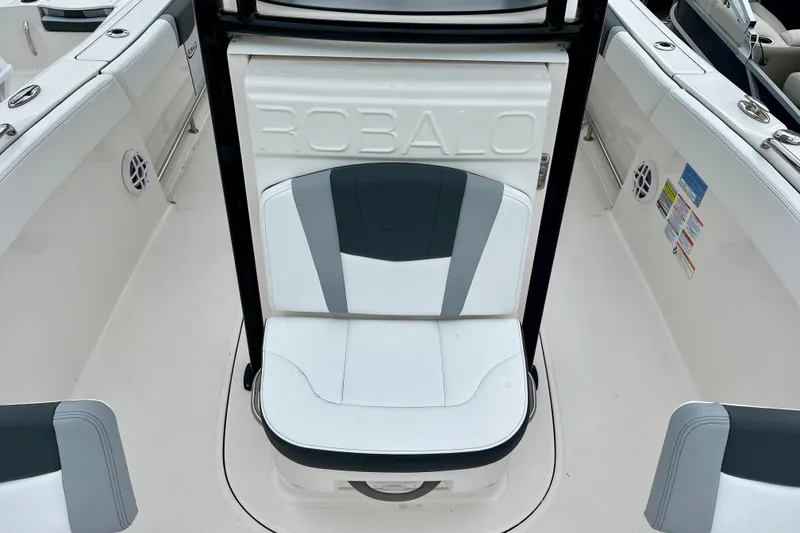 Slide: The Image of 2024 Robalo R230 Center Console boat seating area with sleek design and branding. - 27