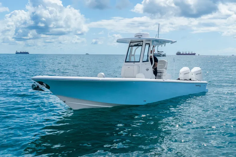 The Image of 2026 Tidewater 2700 Carolina Bay boat on open water under a cloudy sky. - 0