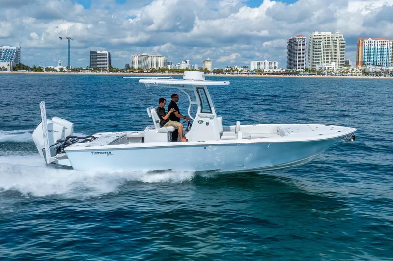 Slide: The Image of 2026 Tidewater 2700 Carolina Bay boat cruising near city skyline. - 11
