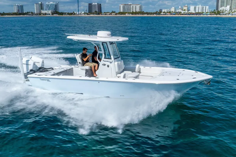 Slide: The Image of 2026 Tidewater 2700 Carolina Bay boat cruising on ocean near city skyline. - 12