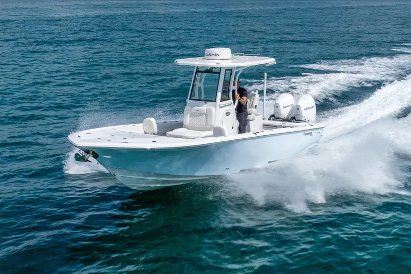 Slide: The Image of 2026 Tidewater 2700 Carolina Bay boat cruising on open water, showcasing sleek design and powerful engines. - 17