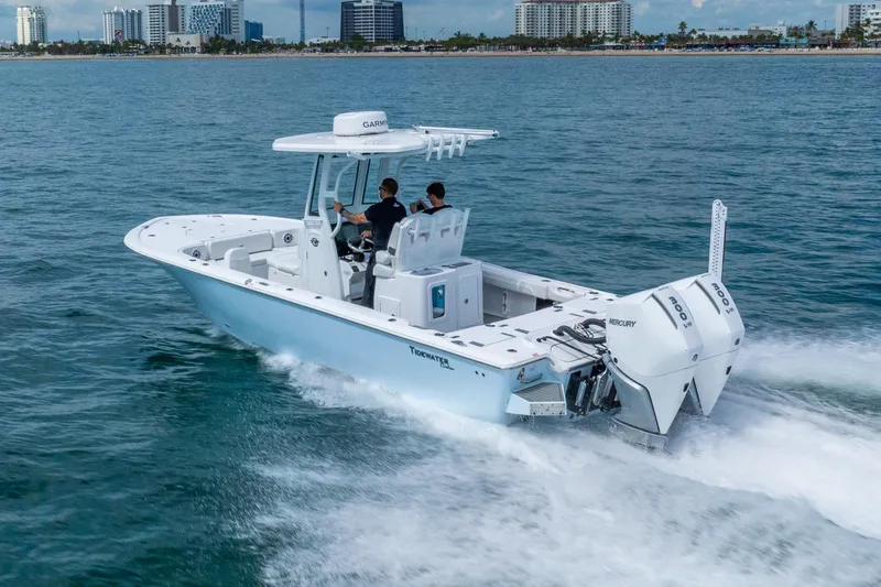 Slide: The Image of 2026 Tidewater 2700 Carolina Bay boat cruising on ocean near city skyline. - 18
