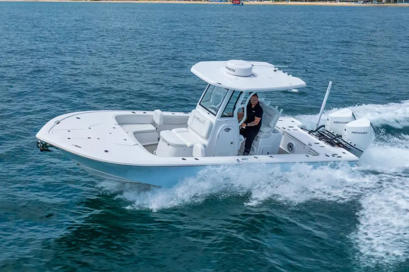 Slide: The Image of 2026 Tidewater 2700 Carolina Bay boat cruising on open water, showcasing sleek design and performance. - 20