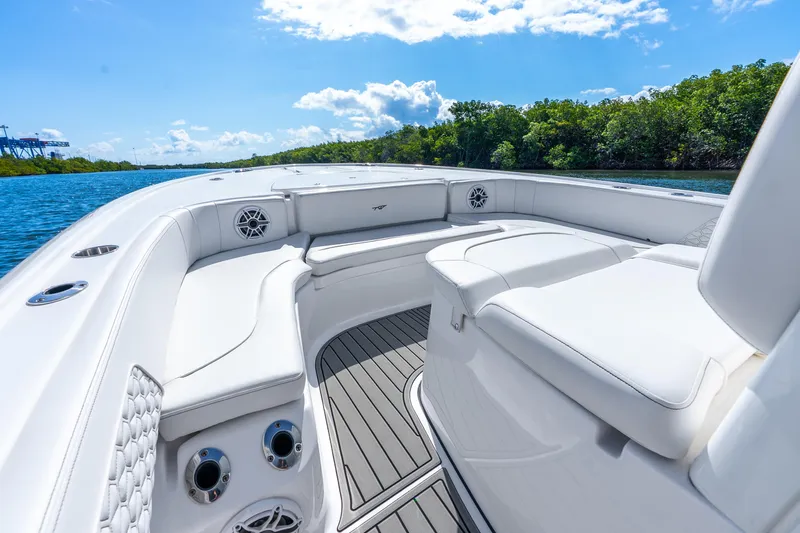 Slide: The Image of 2026 Tidewater 2700 Carolina Bay boat interior with white seating and scenic water view. - 23