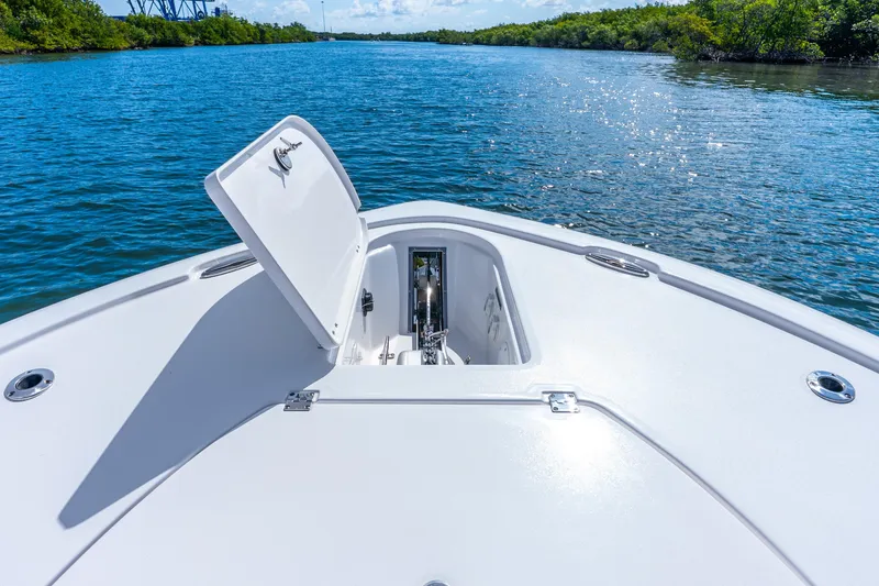 Slide: The Image of Bow view of 2026 Tidewater 2700 Carolina Bay boat on serene waterway. - 25