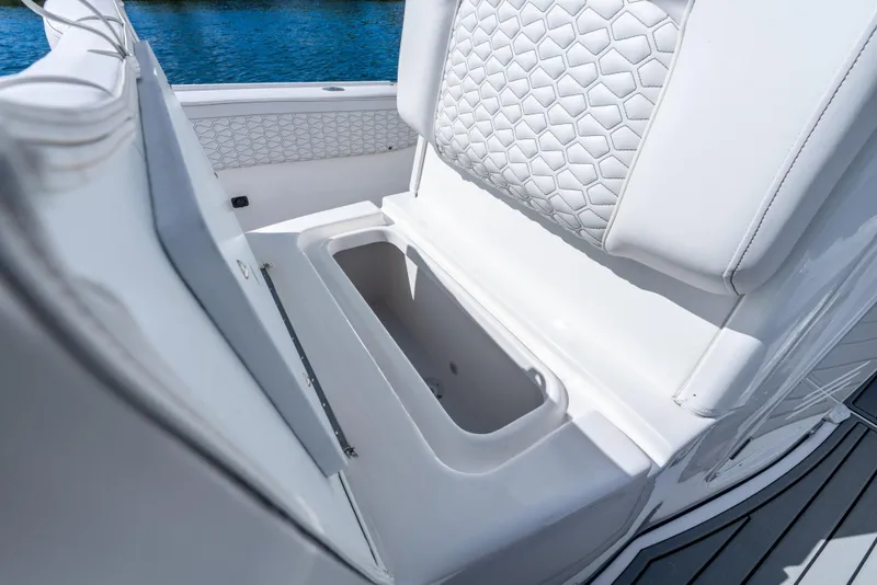Slide: The Image of 2026 Tidewater 2700 Carolina Bay boat seat with storage compartment, featuring hexagonal pattern upholstery. - 26
