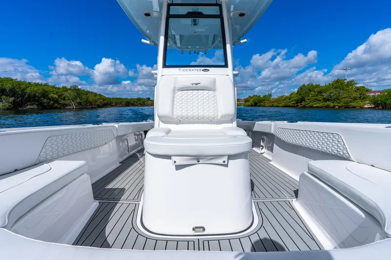 Slide: The Image of 2026 Tidewater 2700 Carolina Bay boat interior with sleek seating and scenic water backdrop. - 28