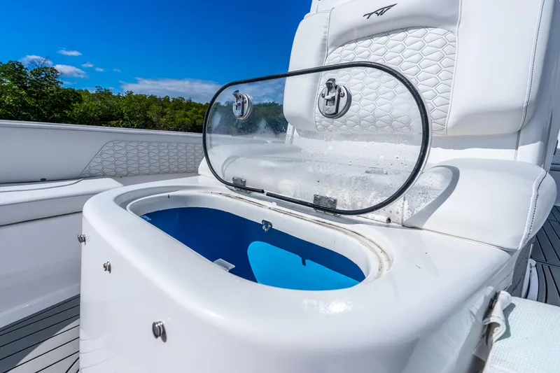 Slide: The Image of 2026 Tidewater 2700 Carolina Bay boat with open storage compartment, white seating, and blue interior. - 29