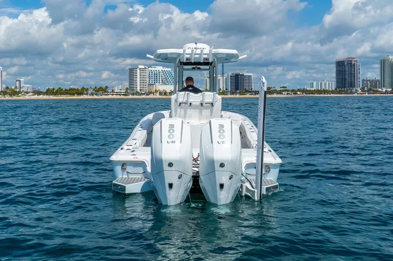 Slide: The Image of 2026 Tidewater 2700 Carolina Bay boat on water with city skyline in background. - 3