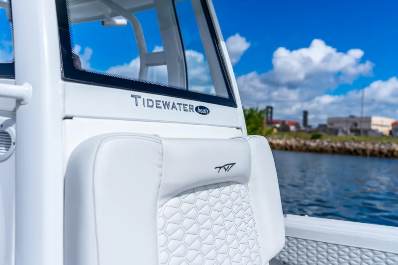 Slide: The Image of 2026 Tidewater 2700 Carolina Bay boat interior with logo, against a scenic waterfront backdrop. - 30