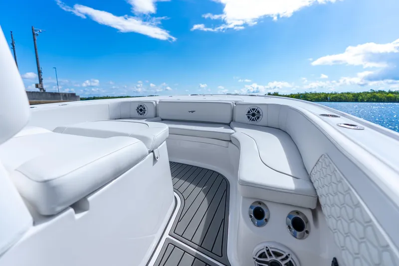 Slide: The Image of 2026 Tidewater 2700 Carolina Bay boat interior with white seating and blue sky background. - 31