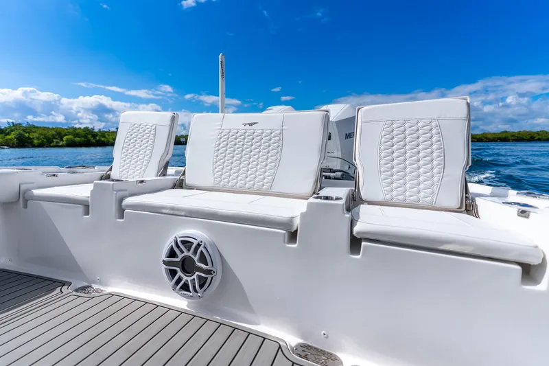 Slide: The Image of 2026 Tidewater 2700 Carolina Bay boat with luxurious seating and scenic water backdrop. - 32