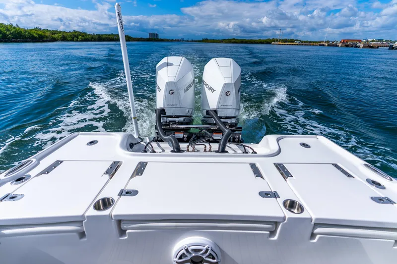 Slide: The Image of 2026 Tidewater 2700 Carolina Bay boat with dual Mercury engines cruising on open water. - 34