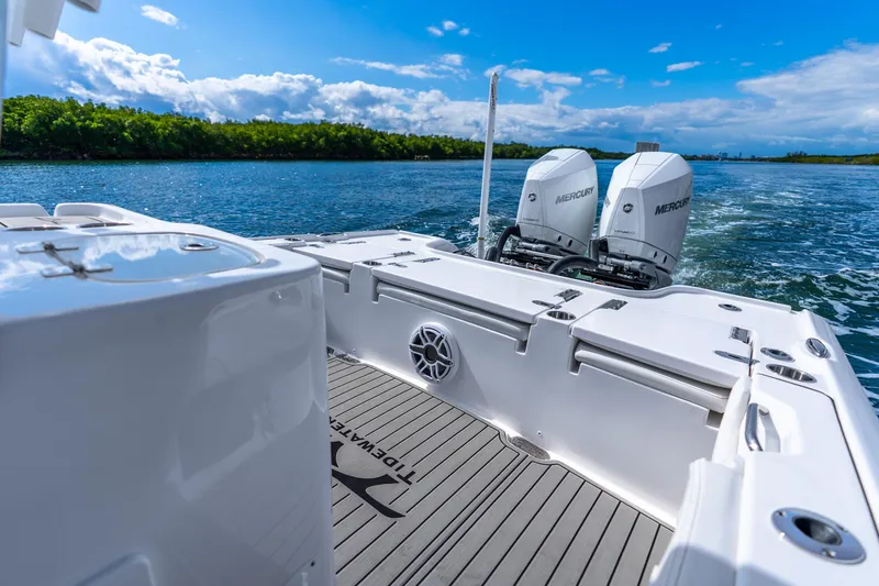 Slide: The Image of 2026 Tidewater 2700 Carolina Bay boat with dual Mercury engines on a scenic waterway. - 35