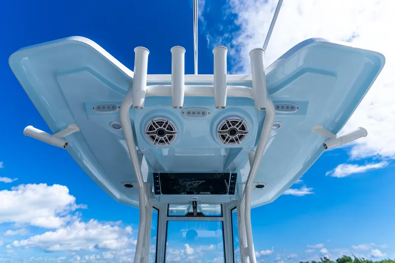 Slide: The Image of Tidewater 2700 Carolina Bay 2026 boat with rod holders and speakers against blue sky. - 38