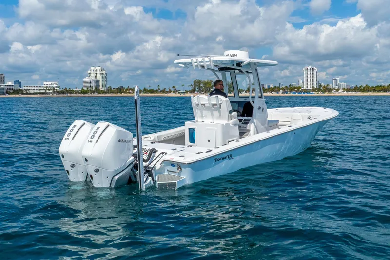 Slide: The Image of 2026 Tidewater 2700 Carolina Bay boat on water, city skyline in background. - 4