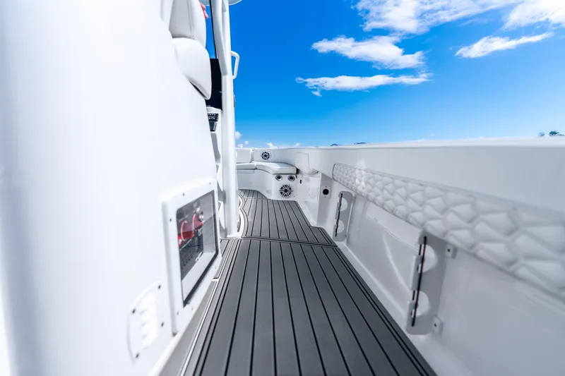 Slide: The Image of 2026 Tidewater 2700 Carolina Bay boat deck with sleek design under blue sky. - 40