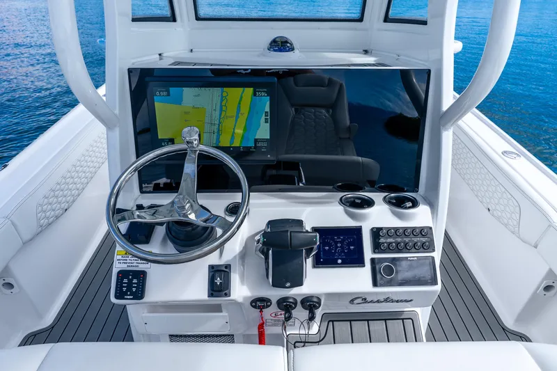 Slide: The Image of Helm of 2026 Tidewater 2700 Carolina Bay boat with navigation display and controls. - 44