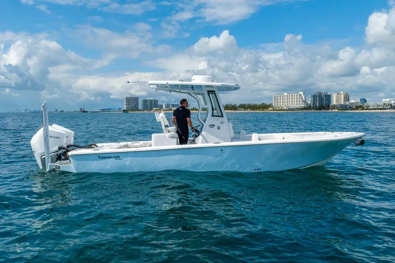Slide: The Image of 2026 Tidewater 2700 Carolina Bay boat on water, city skyline in background. - 5
