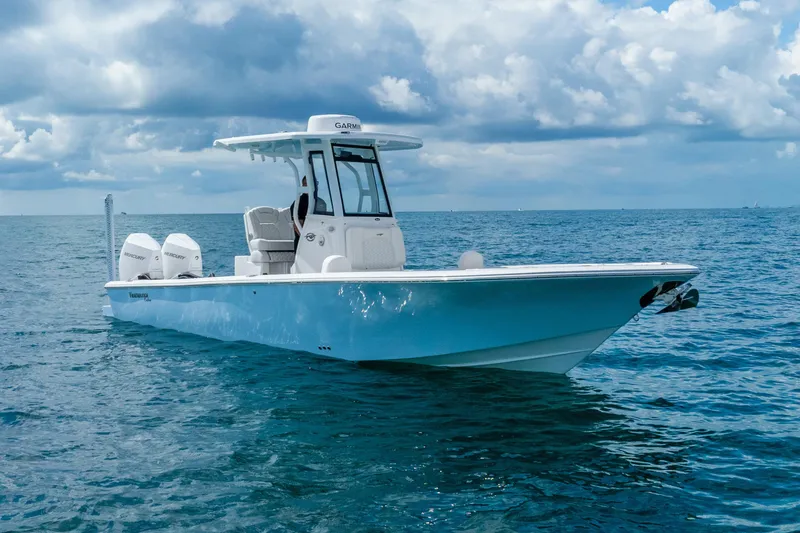 Slide: The Image of 2026 Tidewater 2700 Carolina Bay boat on open ocean under cloudy sky. - 6