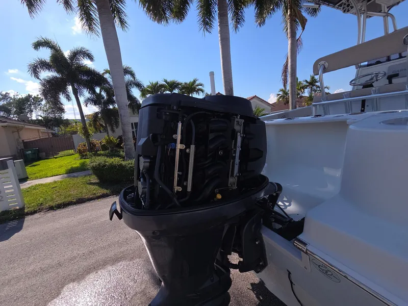 Slide: The Image of Outboard motor of a 2007 Sailfish 218 CC boat under palm trees. - 11