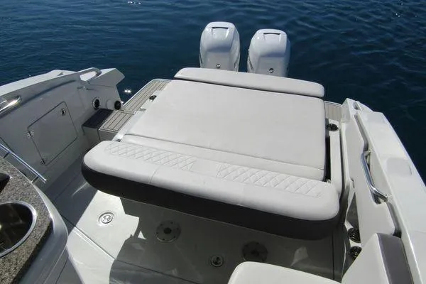 Slide: The Image of 2024 Crownline 310 CRX boat with dual engines and spacious seating on water. - 12