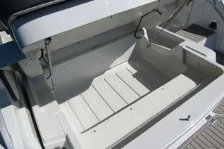Slide: The Image of 2024 Crownline 310 CRX boat storage compartment, open and spacious design. - 13