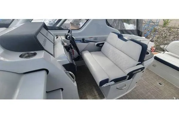 Slide: The Image of 2024 Crownline 310 CRX boat interior with modern helm and comfortable seating. - 4