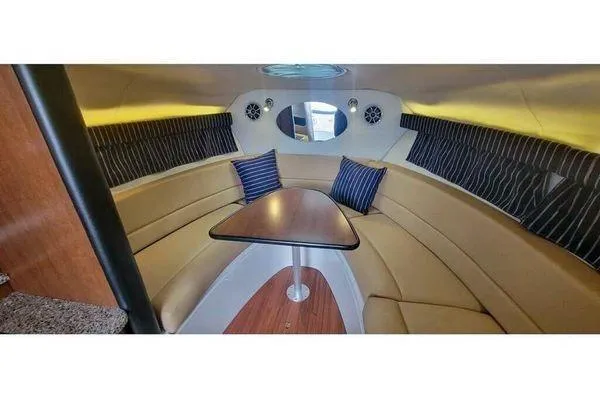 Slide: The Image of Luxurious interior of 2024 Crownline 310 CRX boat with elegant seating and table. - 7