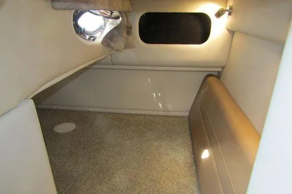 Slide: The Image of 2024 Crownline 310 CRX cabin interior with beige upholstery and ambient lighting. - 8