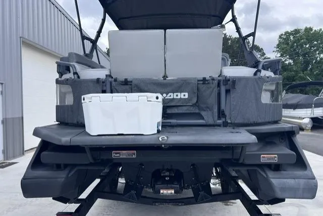 Slide: The Image of 2022 Seadoo Switch pontoon boat rear view with seating and storage box. - 4
